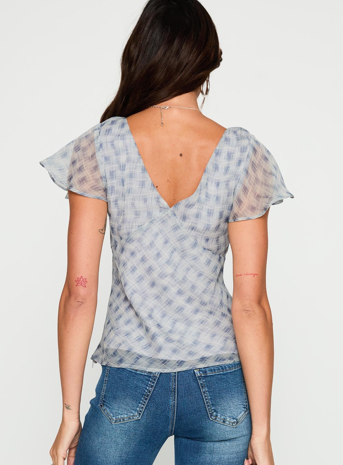 back view of model wearing Princess Polly My Last Love Top Blue Check Short Sleeves Plunger 