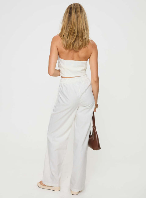 White Matching linen set Halter neck top, fixed halter strap, button fastening at front, twin hip pockets High rise pants, belt looped waist, zip and button fastening, elasticated waistband at back, twin hip pockets, straight leg