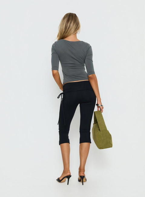 back view of model wearing Princess Polly Bailor Channel Waistband Capri Pants Black Mid Rise Pants 