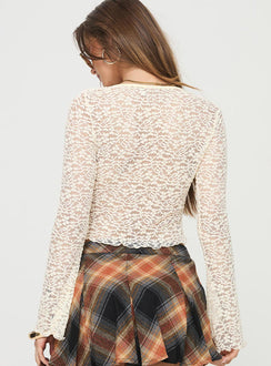 Long sleeve top  Lace material, scoop neckline, tie detail at bust, slightly flared sleeves, sheer design Good stretch, unlined