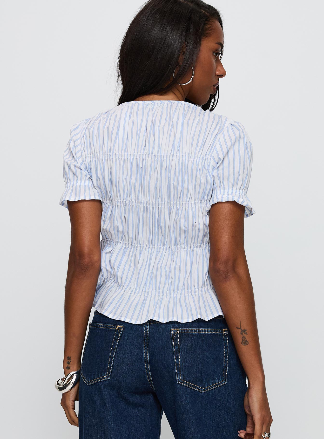 back view of model wearing Princess Polly Alistair Bow Tie Top Blue / White Stripe Short Sleeves Crew Neck 