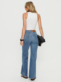 back view of model wearing Princess Polly Thearlie High Rise Flared Jeans Mid Blue Wash High Rise Jeans 