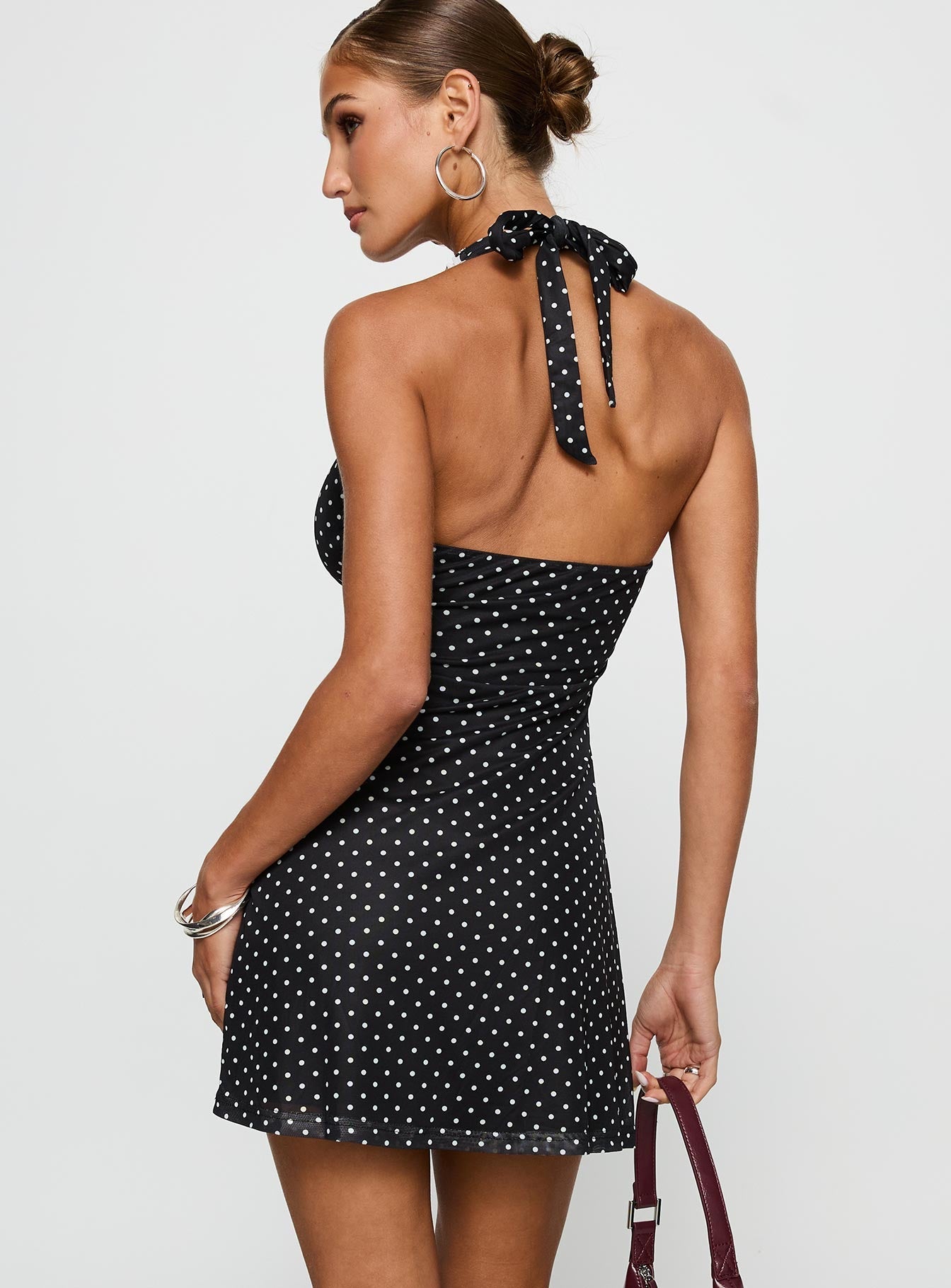 back view of model wearing Princess Polly Black Beauty Halter Mini Dress Black / Polka Plunger 