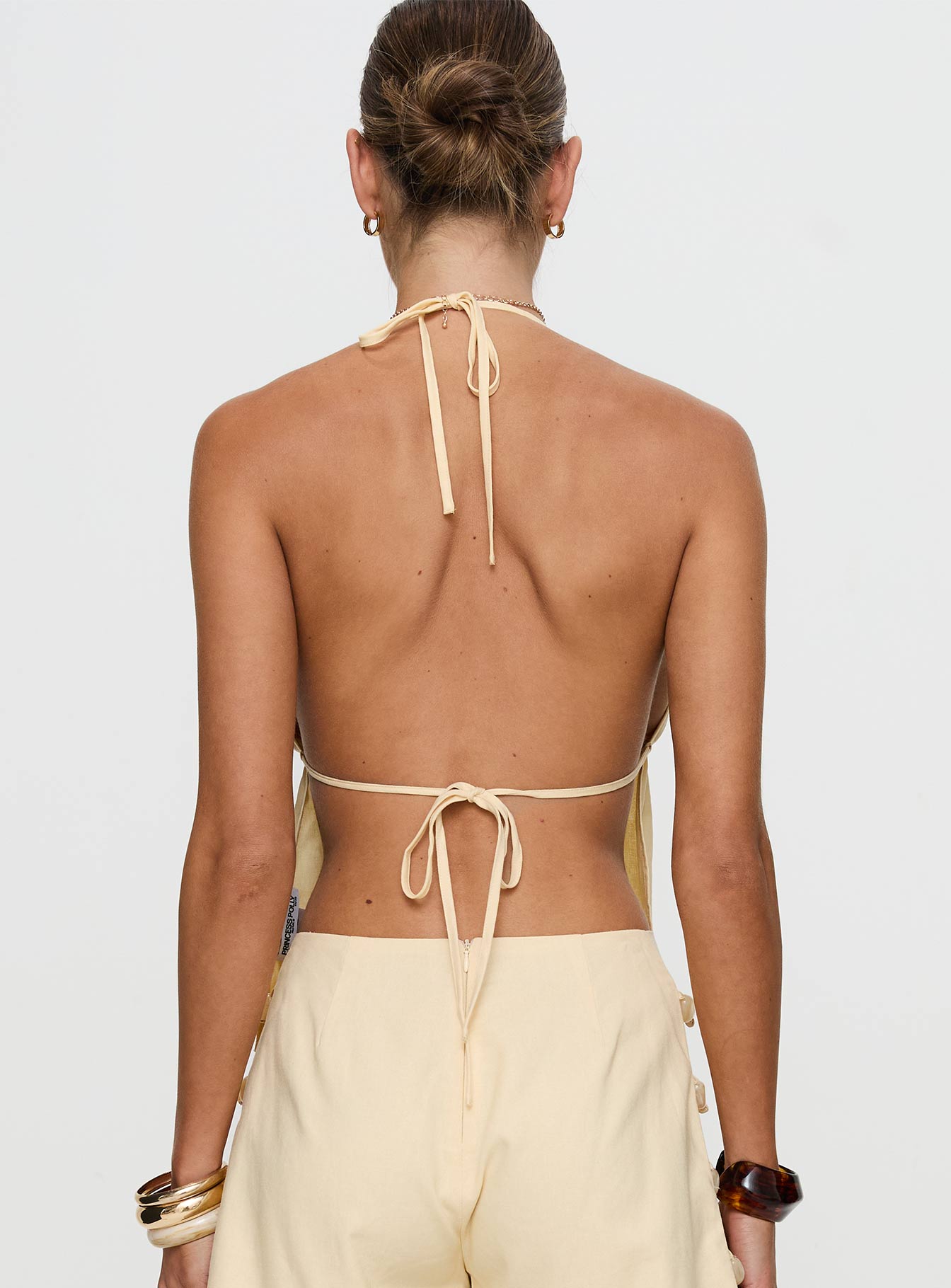 back view of model wearing Princess Polly Solid Gold Top Lemon Sleeveless Plunger 