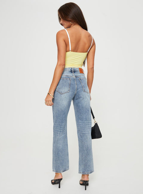Mid rise denim jeans Asymmetrical waistband, relaxed straight leg, button front fastening, belt loops at waist, distressed detailing on hem