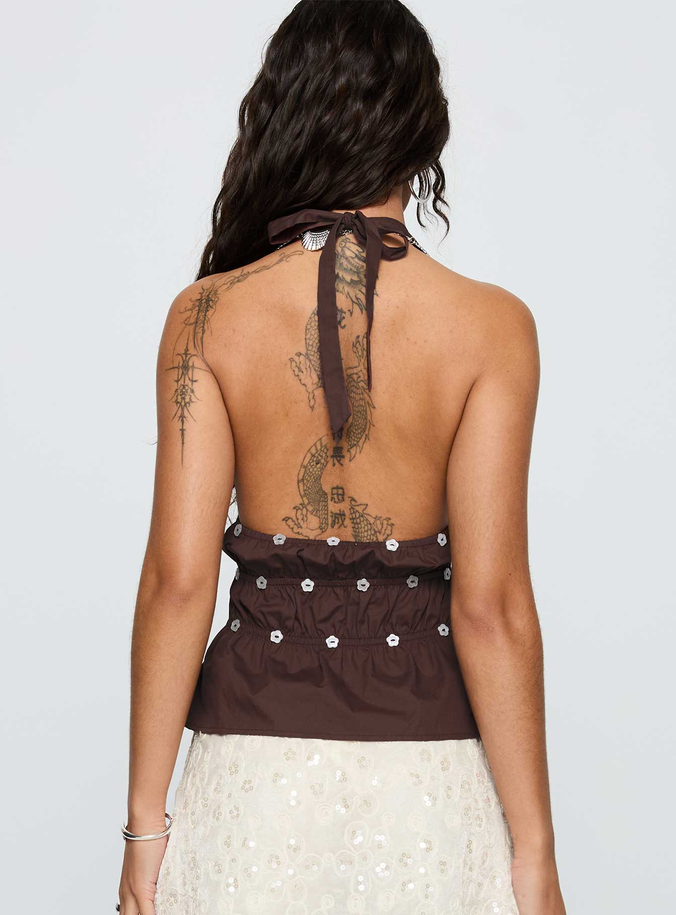 back view of model wearing Princess Polly Movies End Halter Top Brown Sleeveless Plunger 