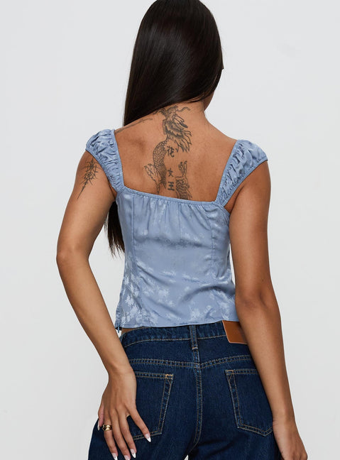 back view of model wearing Princess Polly Branwen Cap Sleeve Tie Detail Top Blue Floral Sleeveless Sweetheart 