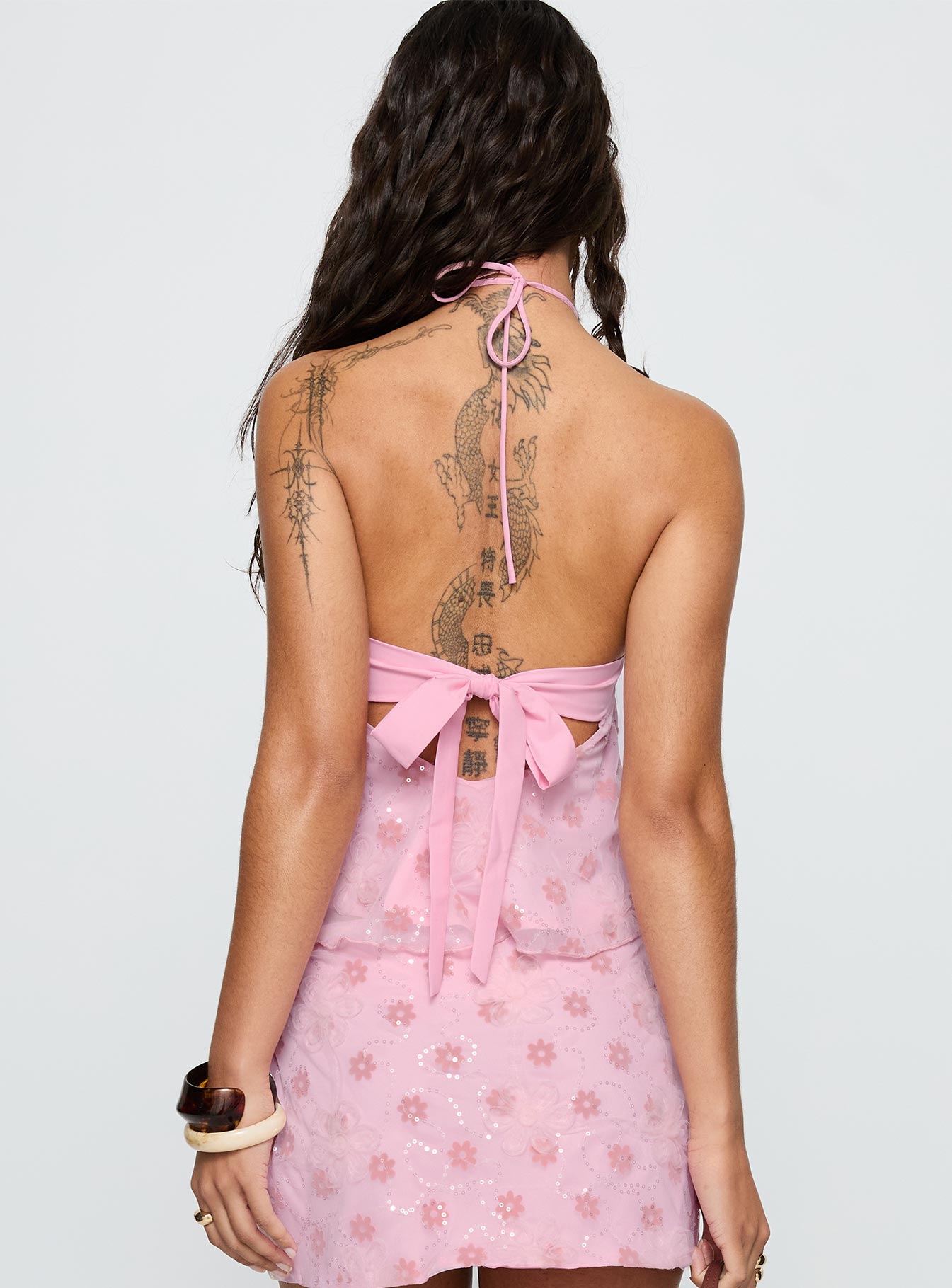 back view of model wearing Princess Polly Remembering Tie Back Top Pink Sleeveless Asymmetric Neckline 