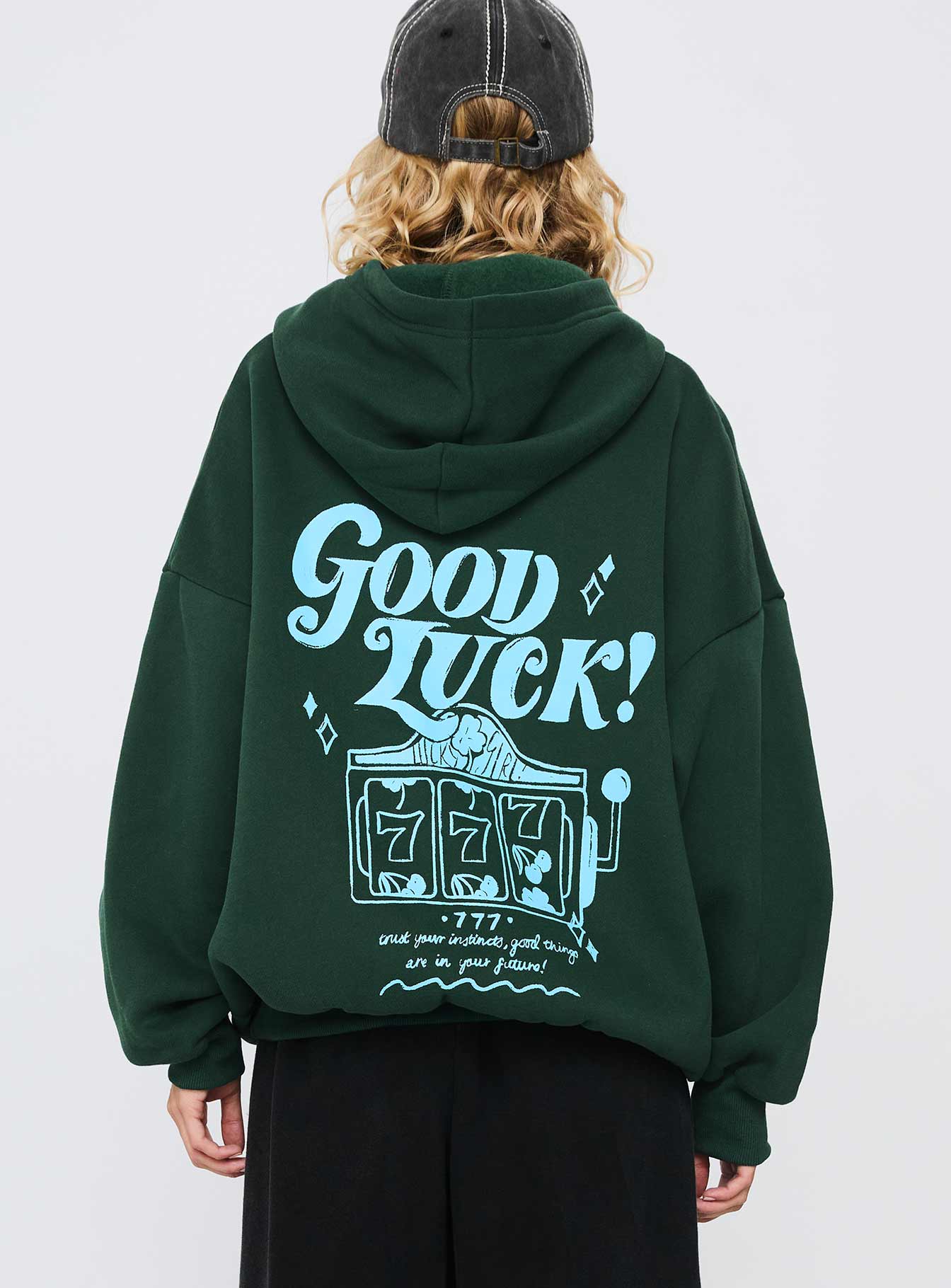 back view of model wearing Princess Polly Good Luck Graphic Hoodie Green / Blue Long 