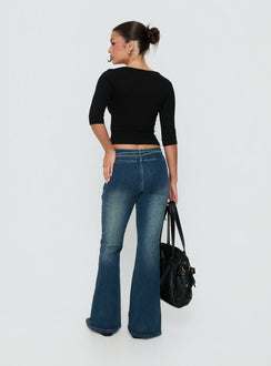 Presenting Runa Low Rise Tie Side Jeans Mid Blue Wash womens-jeans with flared wide-leg design back view of model wearing Princess Polly