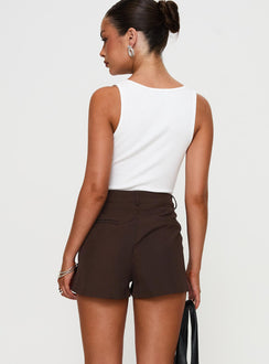back view of model wearing Princess Polly Ellerie Tailored Shorts Chocolate High Waisted Shorts 