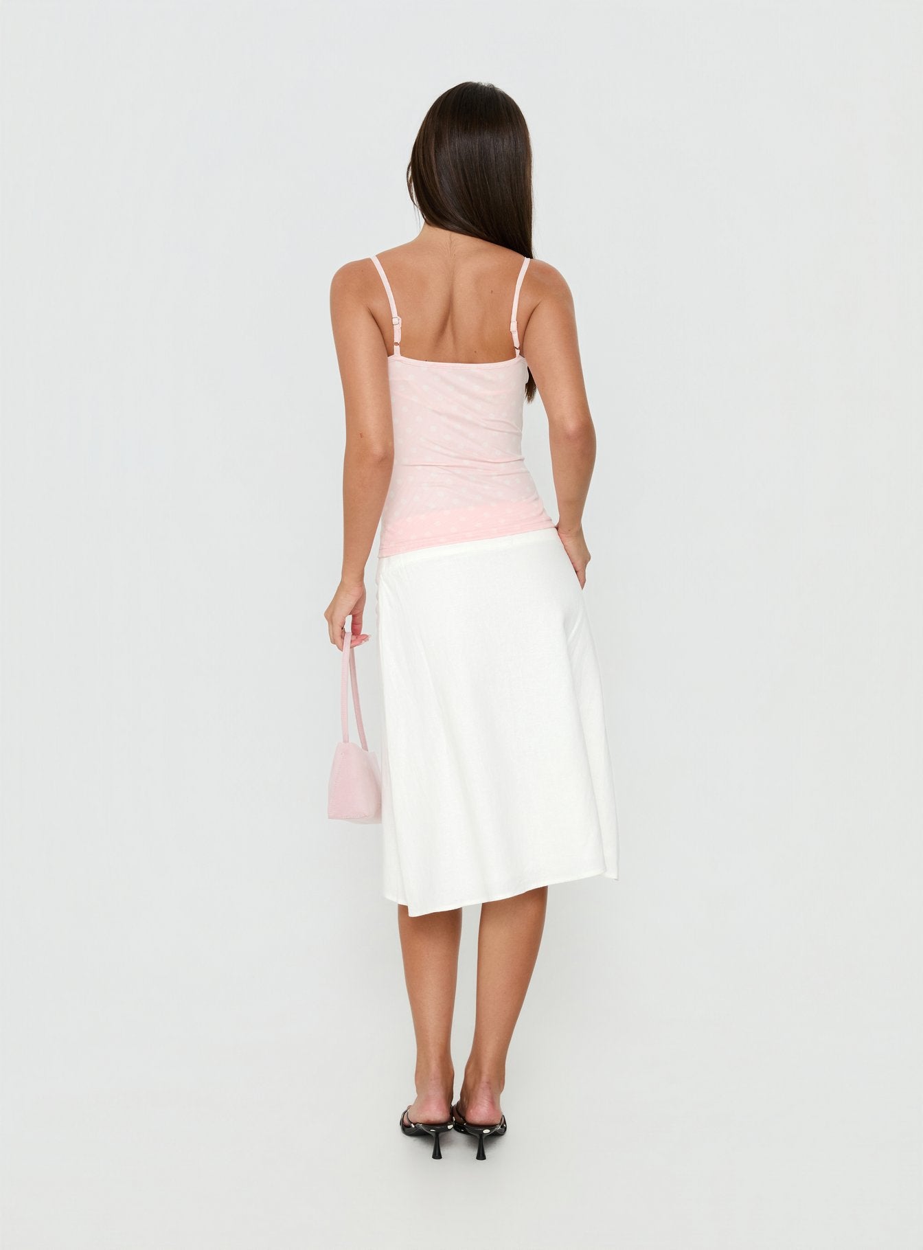 Wearing the Such Delight Linen Midi Skirt in white for womens-skirts, featuring a fitted aline shape back view of model wearing Princess Polly
