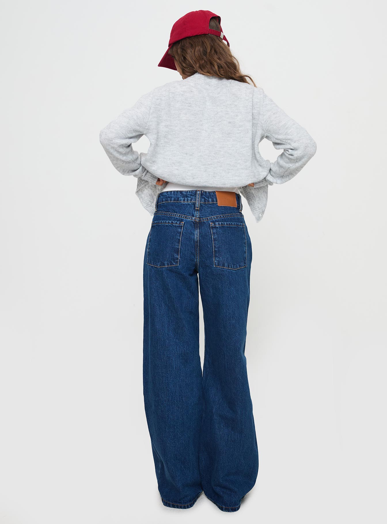 back view of model wearing Princess Polly Shima Low Rise Slouch Jeans Mid Wash Mid Rise 