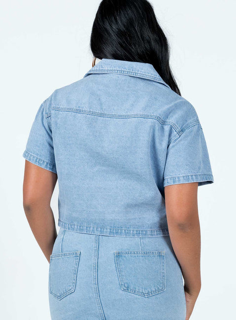 Cropped denim jacket Light wash denim Short sleeves Classic collar Buttons fastening at front Twin chest pockets