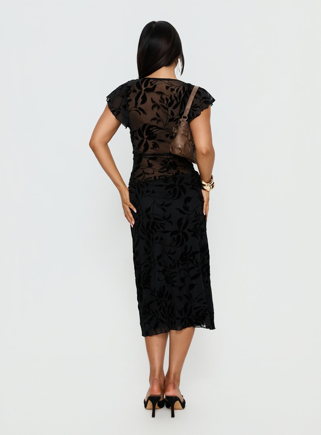 back view of model wearing Princess Polly Atira Midi Skirt Leaf Flower Black Midi Skirts 