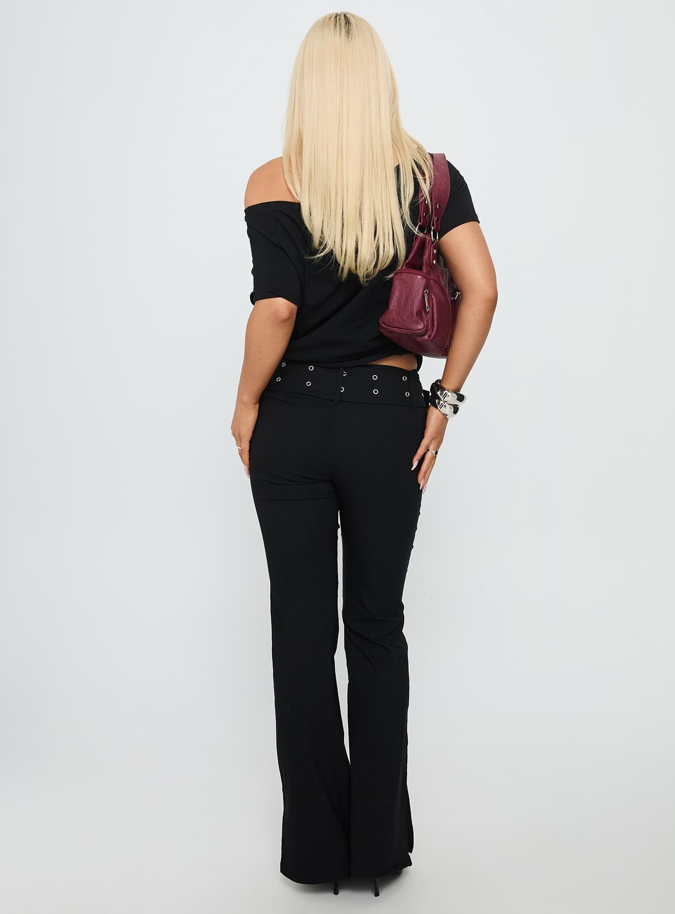back view of model wearing Princess Polly Kortnee Eyelet Detail Flare Leg Pants Black Low Rise Pants 