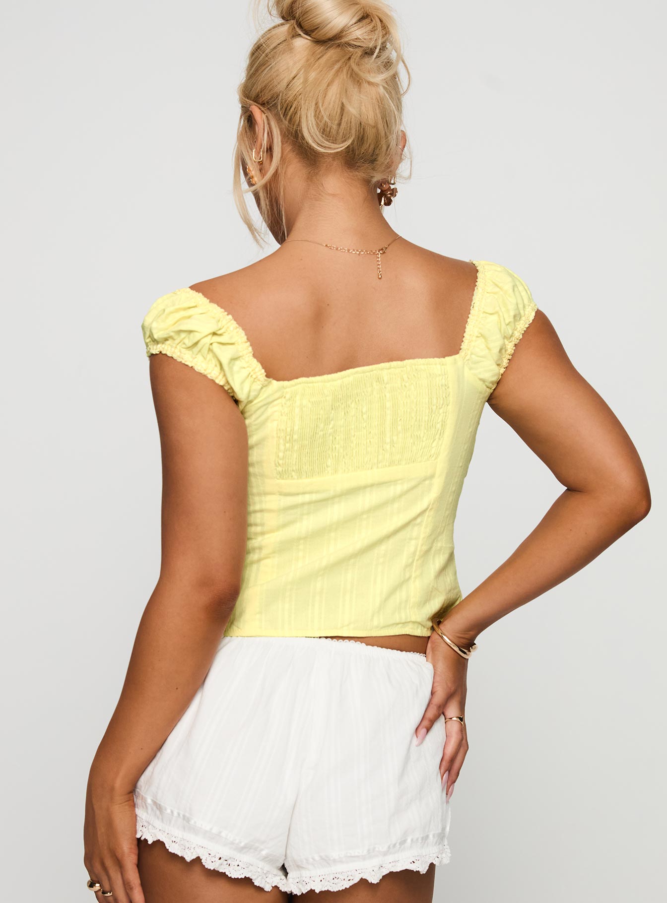 back view of model wearing Princess Polly Fyrie Top Yellow Sleeveless Sweetheart 