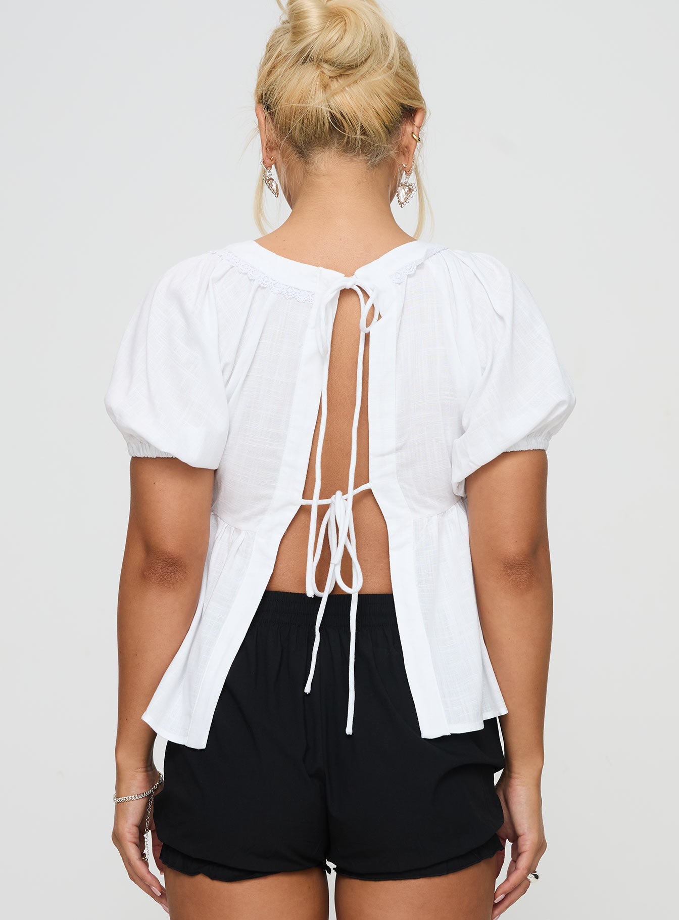 back view of model wearing Princess Polly Weyes Smock Top White Short Sleeves Scoop Neck 
