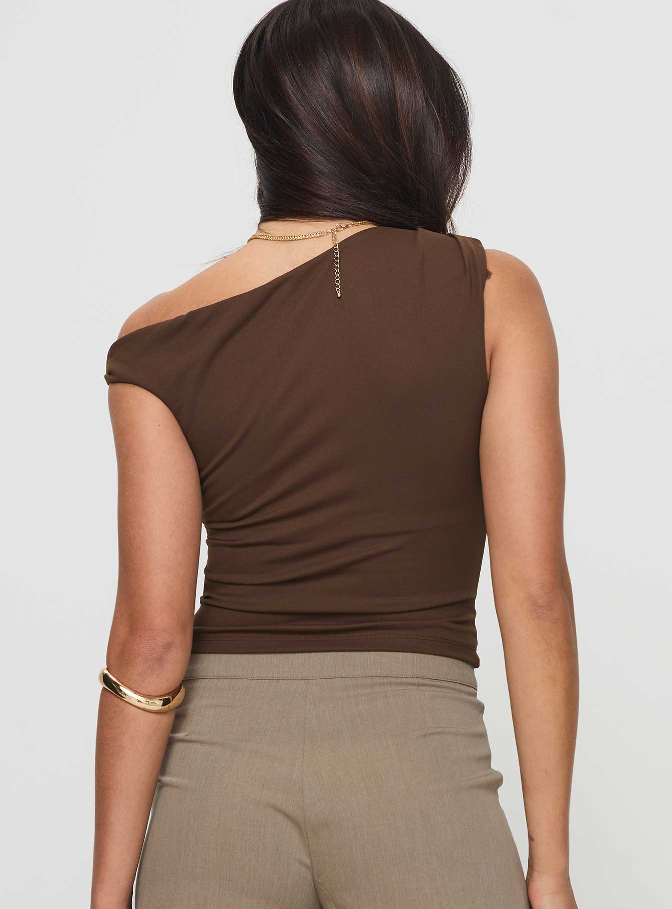 back view of model wearing Princess Polly Danza Top Brown Sleeveless Asymmetric Neckline 