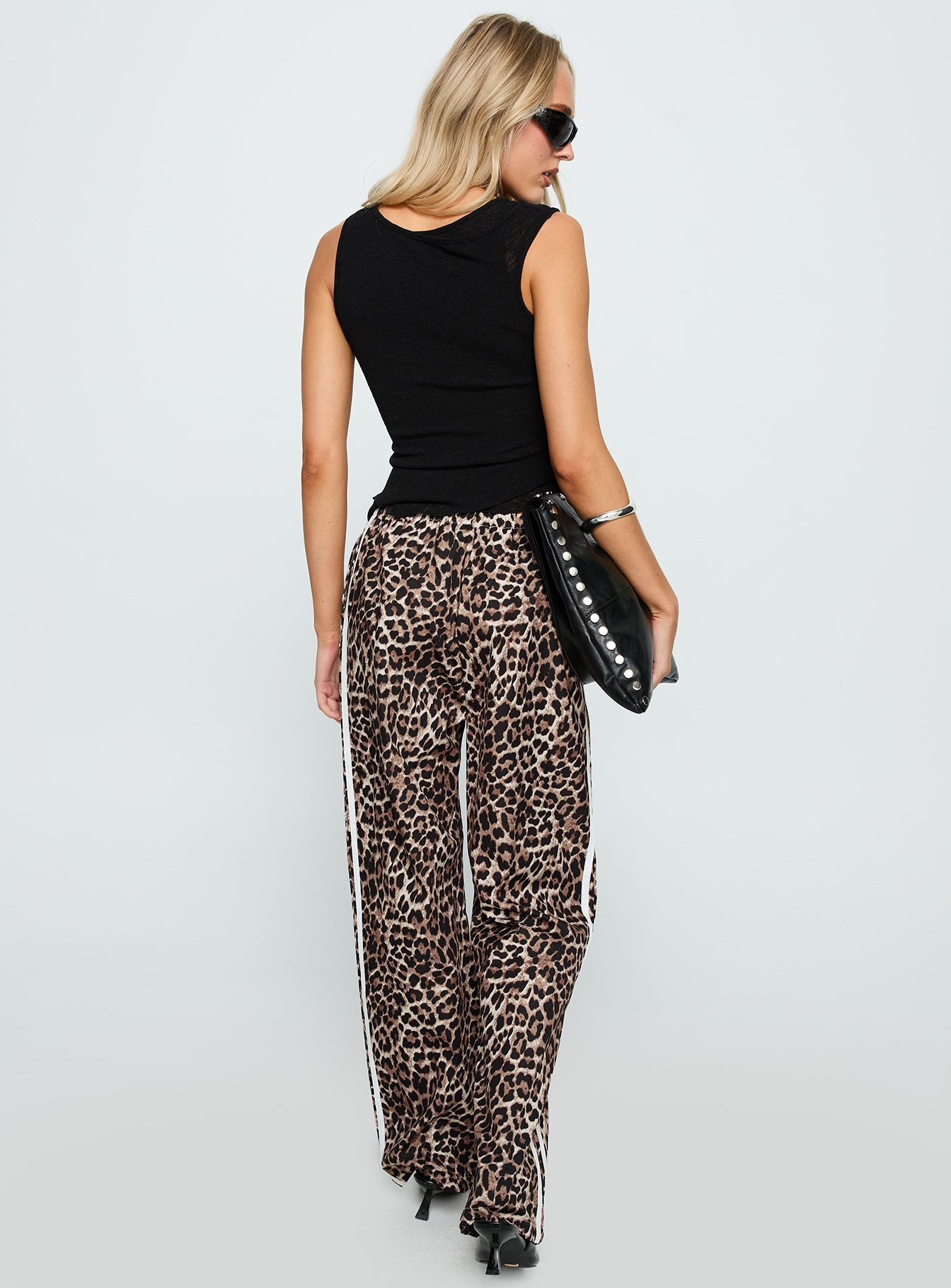 back view of model wearing Princess Polly Buzzer Track Pants Leopard High Waisted Pants 
