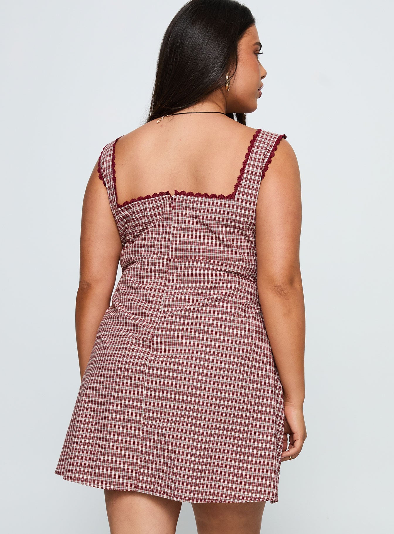 back view of model wearing Princess Polly Dasha Mini Dress Red Check Curve Square Neck 