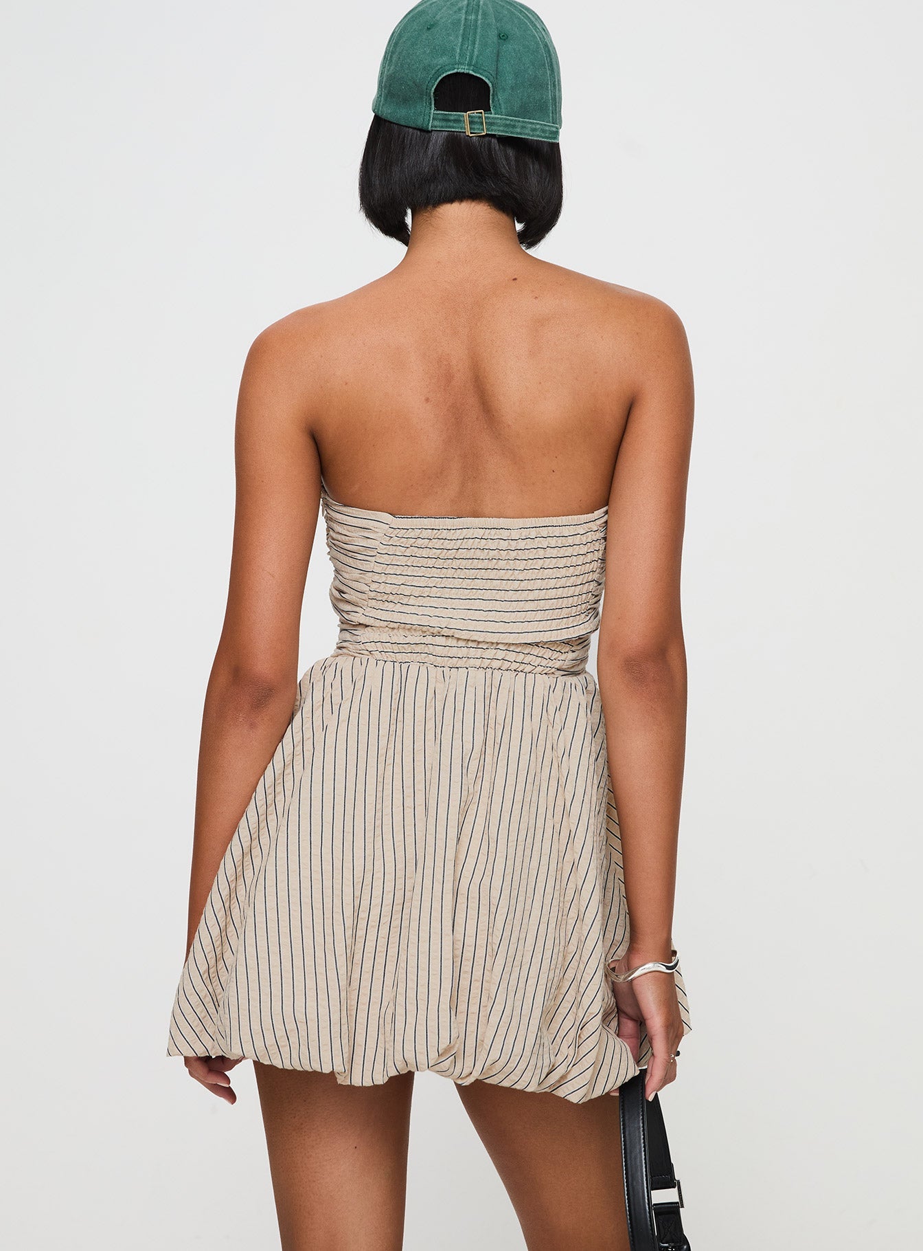 back view of model wearing Princess Polly Quinette Strapless Bubble Hem Mini Dress Beige Stripe Straight Neck 