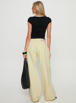 back view of model wearing Princess Polly Ramos Low Rise Wide Leg Jeans Butter Lemon Low Rise Jeans 