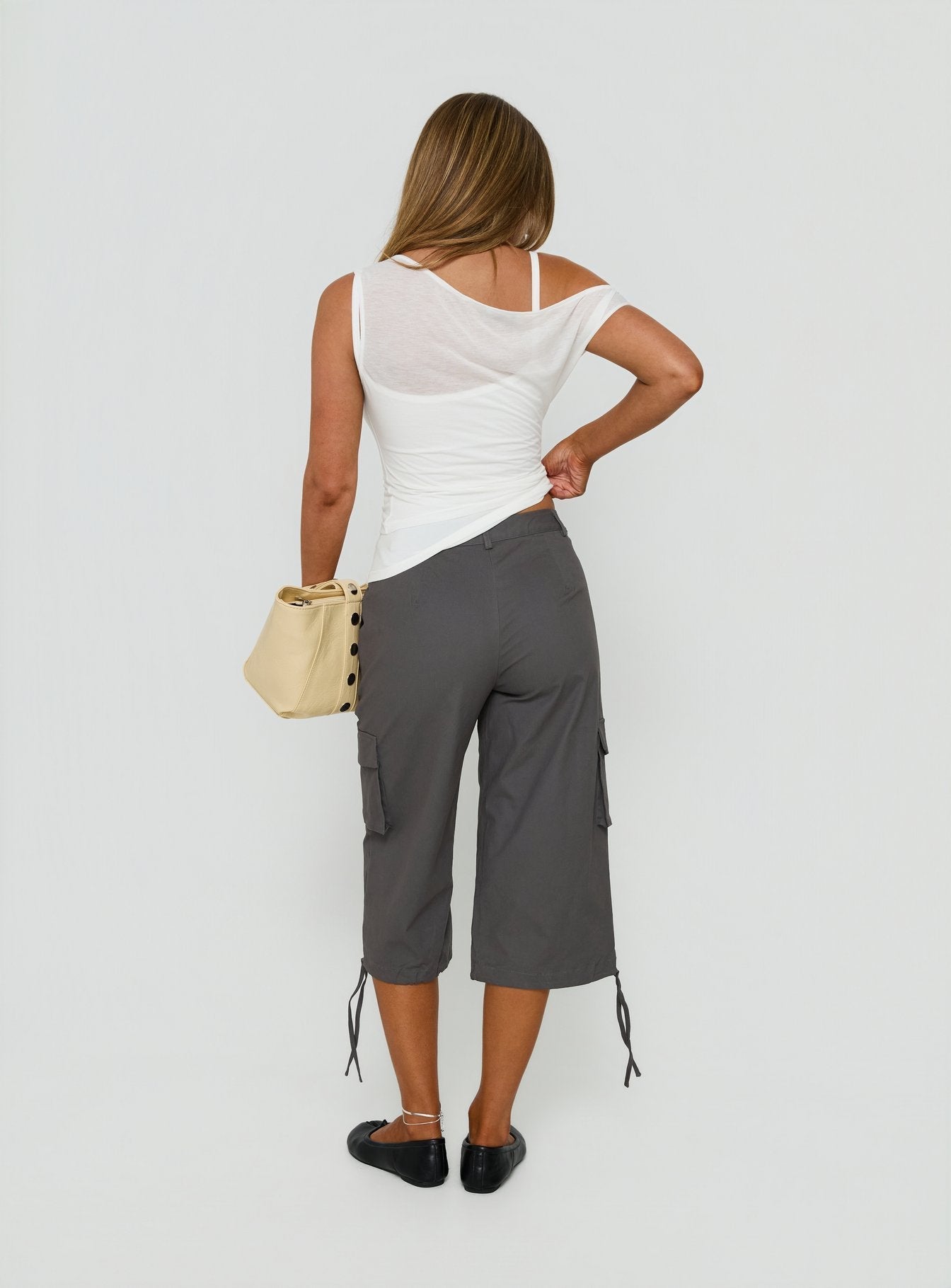 Presenting the Alfonza Utility Capri in Slate womens-regular-pants with mid-rise cargo construction back view of model wearing Princess Polly