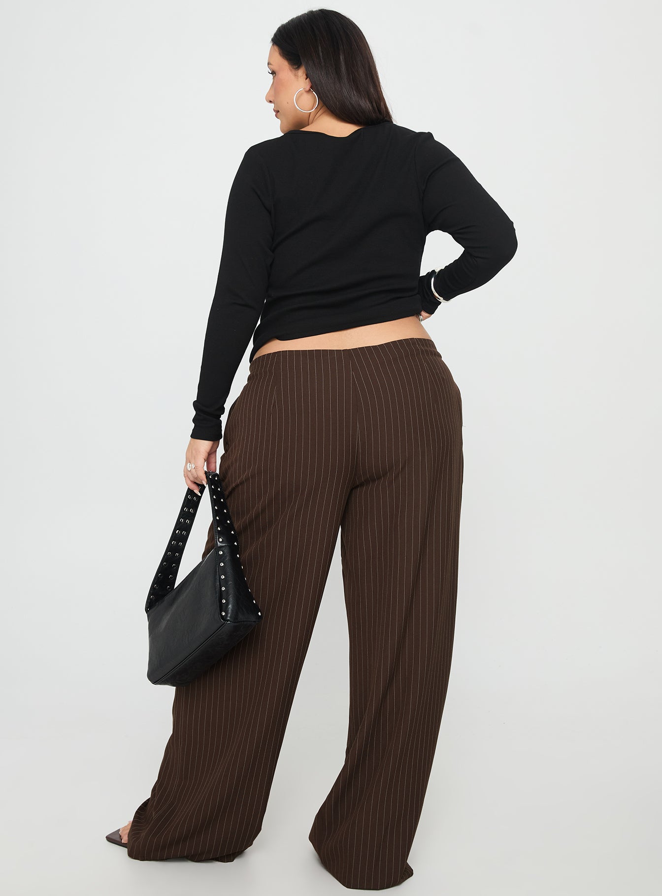 back view of model wearing Princess Polly Khane Low Rise Wide Leg Pant Brown Pinstripe Curve Low Rise Pants 