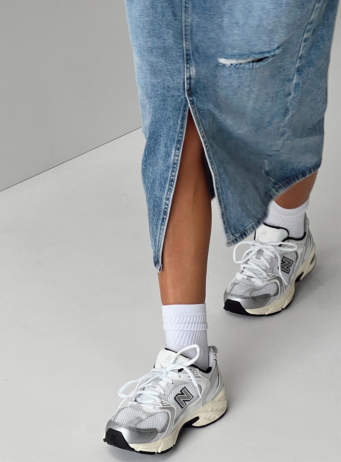 Sneakers Mesh netting throughout Lace up fastening Pull tab at heel Treaded sole Padded footbed