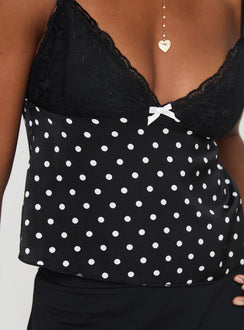 side view of model wearing Princess Polly Castien Top Black Polka Sleeveless Plunger 