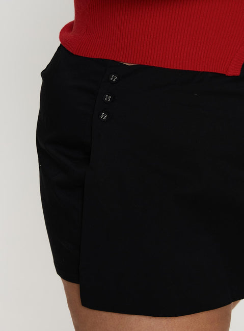 side view of model wearing Princess Polly Sora Skort Black Curve High Waisted Shorts 