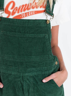 Khaki overalls Cord material  Adjustable shoulder straps  Button fastening at hips  Chest pocket 