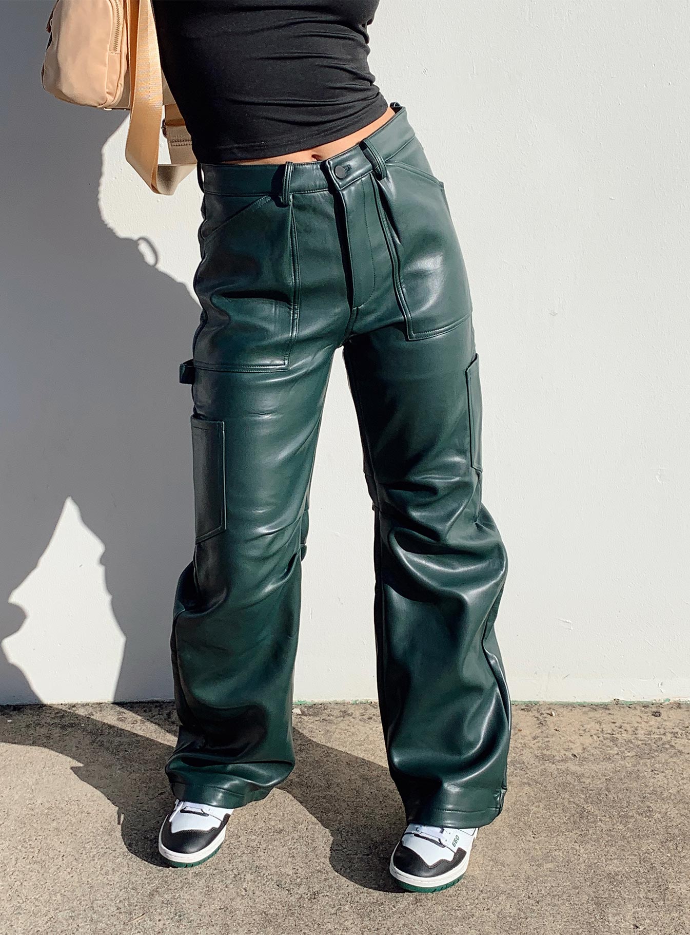 Pants 100% PU Faux leather material  Zip & button fastening  Belt looped waist  Six pockets  Pleated at inner thigh  Wide leg 