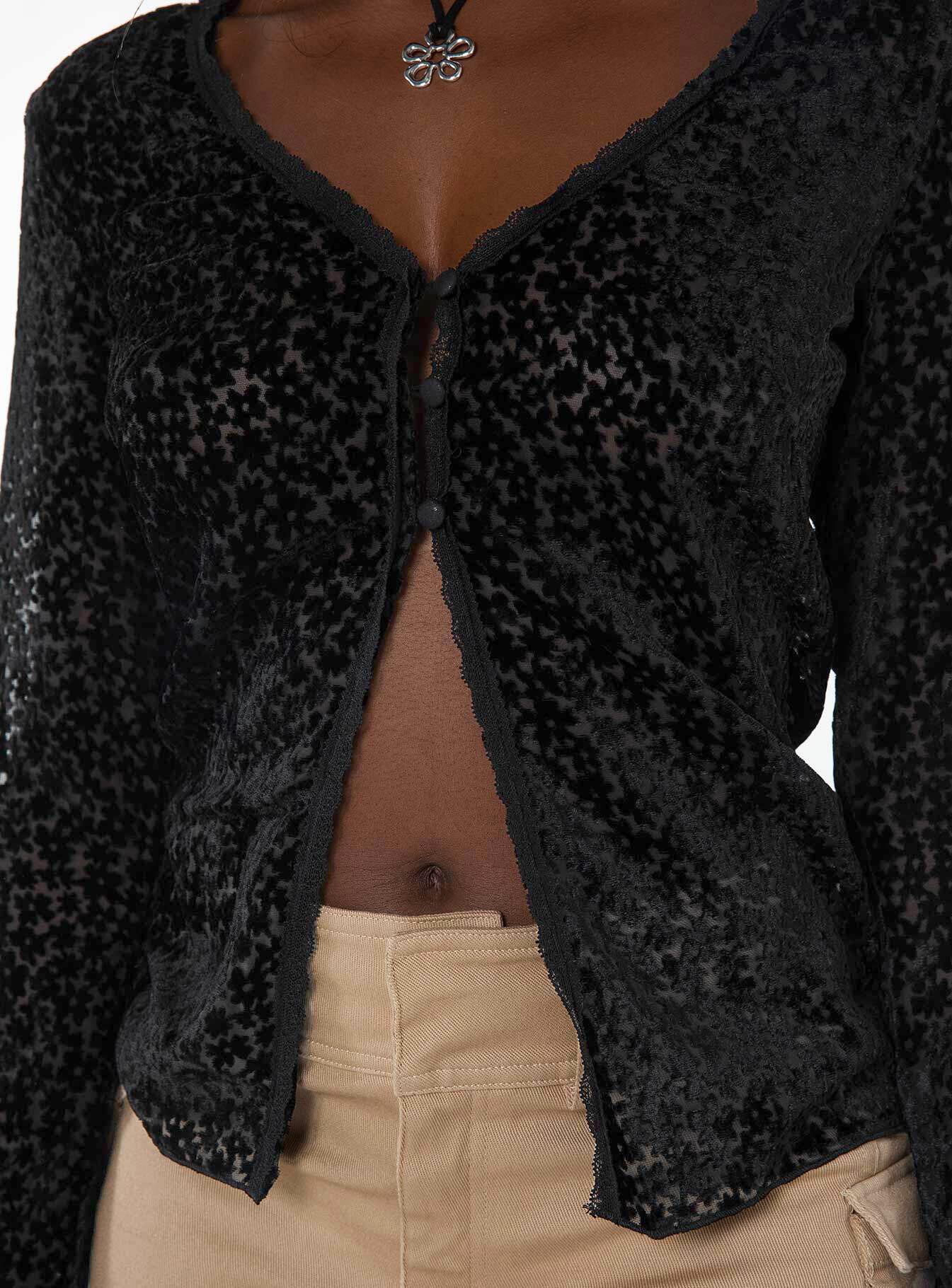 Long sleeve top, v-neckline Button fastening at front, split hem, lace trim