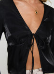 Long sleeve top Shiney material, v neckline, tie fastening at bust, split hem Non-stretch material, unlined 
