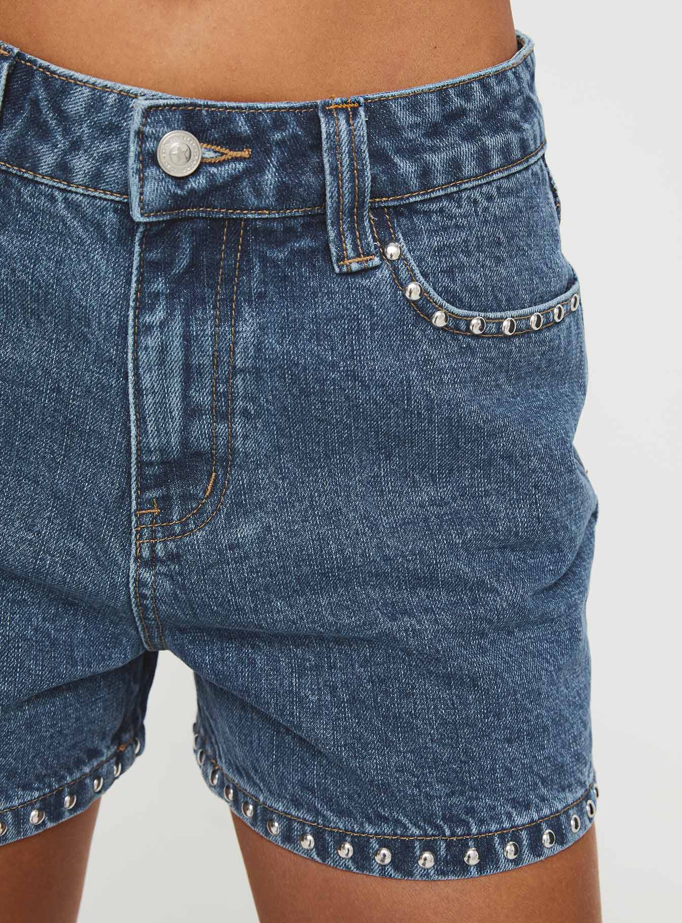 Denim shorts High rise fit, silver studded detailed, classic five pocket design, belt loops at waist, zip and button fastening, branded patch at back