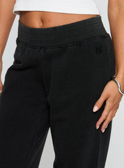 back view of model wearing Princess Polly Summits Flared Track Pants Washed Black High Waisted Pants 