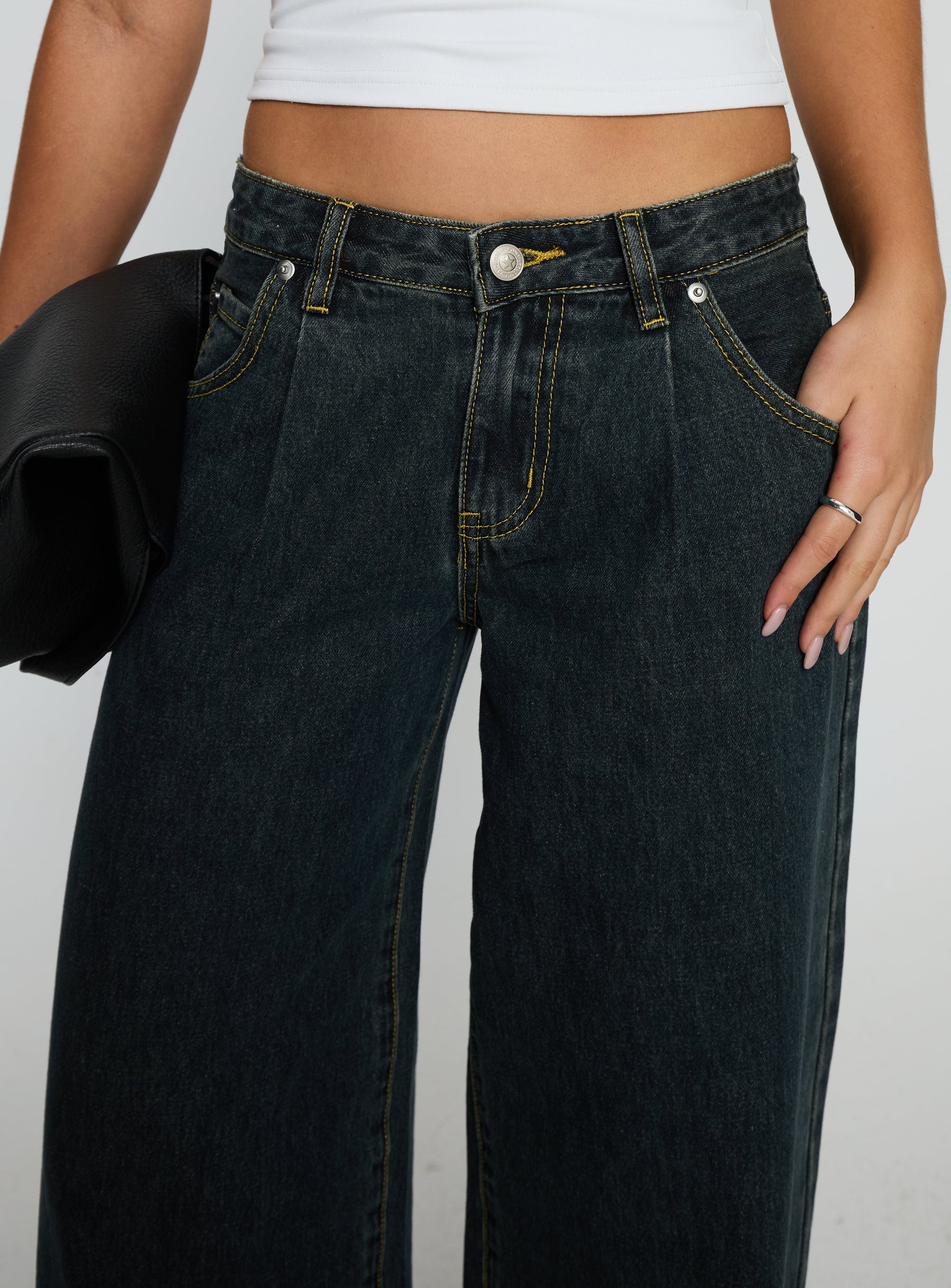 side view of model wearing Princess Polly Supercut Low Rise Baggy Pleat Jeans Grunge Wash Low Rise Jeans 