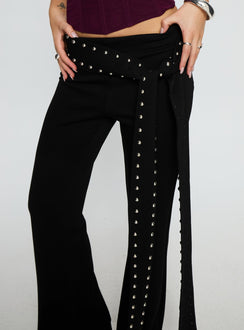 back view of model wearing Princess Polly Nikolia Studded Wrap Belt Pants Black Mid Rise Pants 