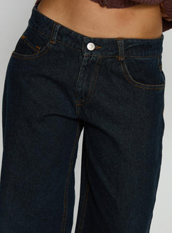 side view of model wearing Princess Polly Korinne Low Rise Bootleg Jeans Indigo Low Rise Jeans 