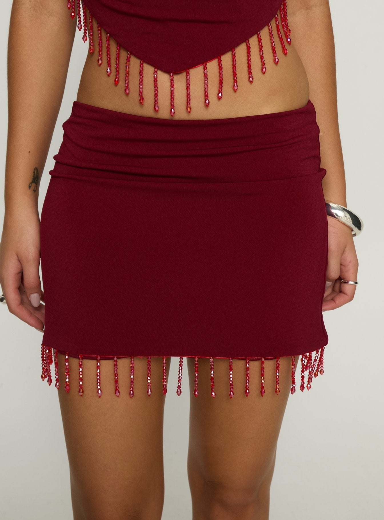 back view of model wearing Princess Polly Ginah Bead Tassel Mini Skirt Red Mini Skirts 