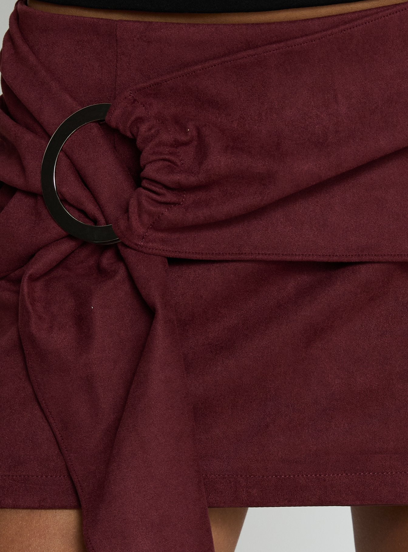   side view of model wearing Princess Polly Lowretta Faux Suede Belt Mini Skirt Burgundy Mini Skirts 