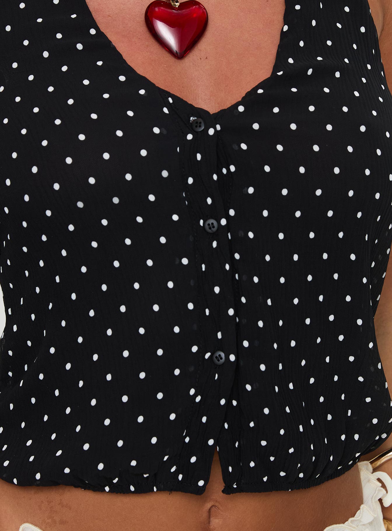 back view of model wearing Princess Polly Brat Halter Top Onyx Polka Sleeveless V-Neck 