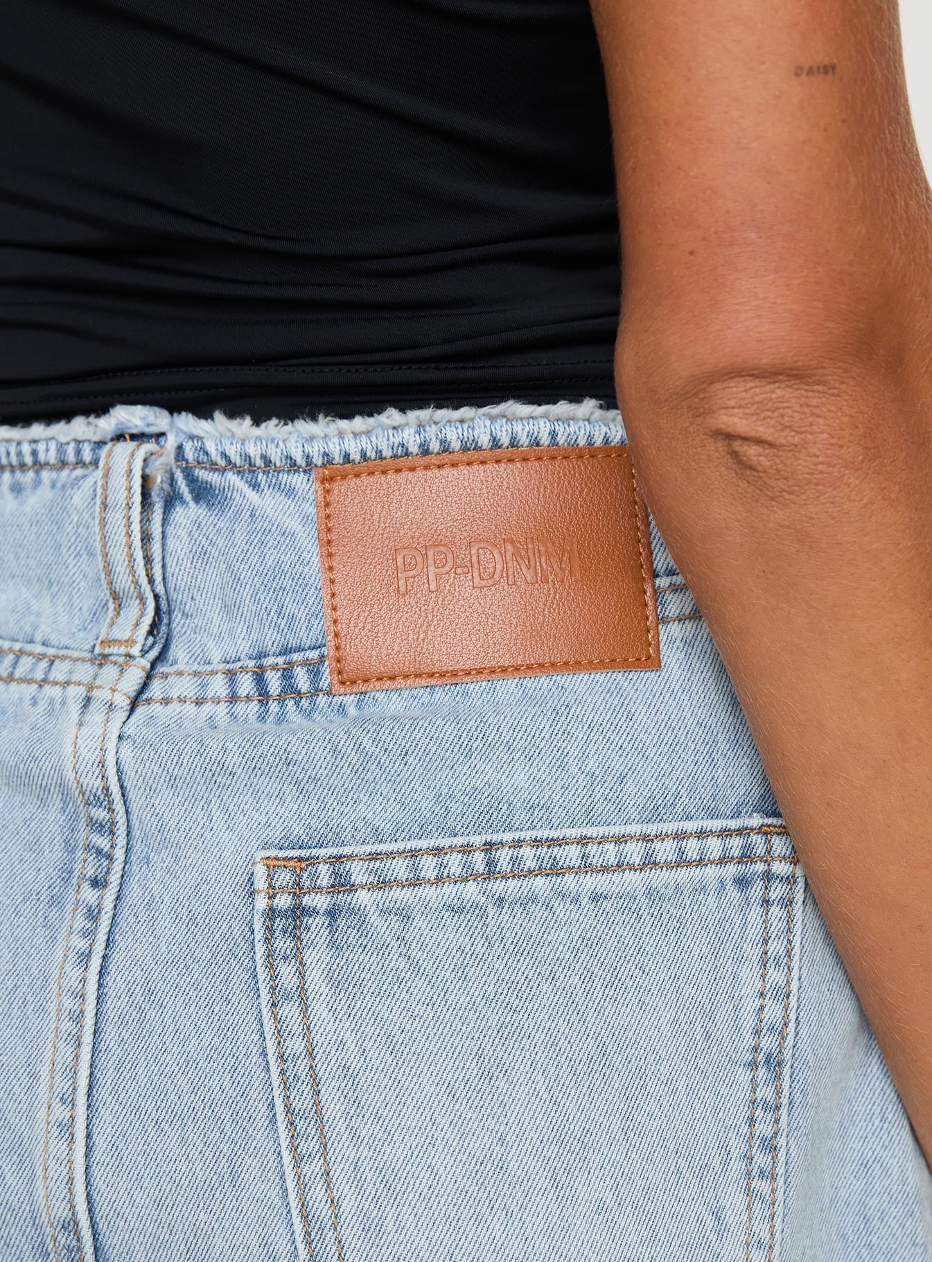 Denim mini skirt High rise fit, belt looped waist, zip and button fastening, raw edge hem Non stretch material, unlined