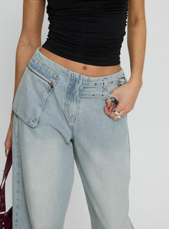 back view of model wearing Princess Polly Paltrow Mid Rise Wide Leg Cargo Jeans Faded Blue Wash Mid Rise Jeans 