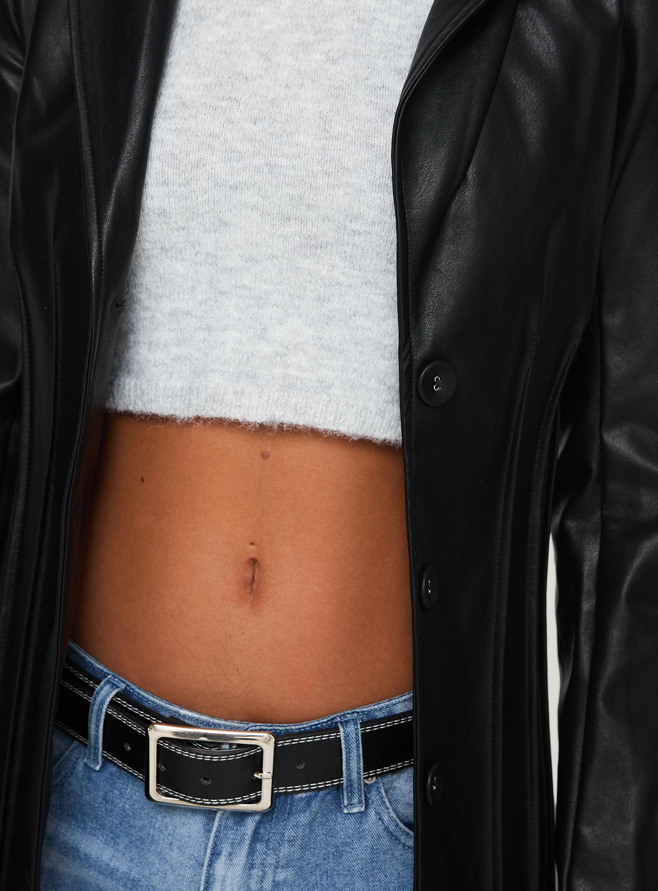 <ul> <li>Faux leather coat</li> <li>Lapel collar, button fastening down front, shoulder pads</li> </ul>