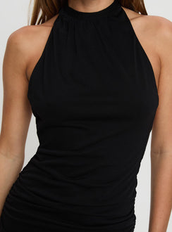 front view of model wearing Princess Polly Capriana Halter Low Back Mini Dress Black High Neck 