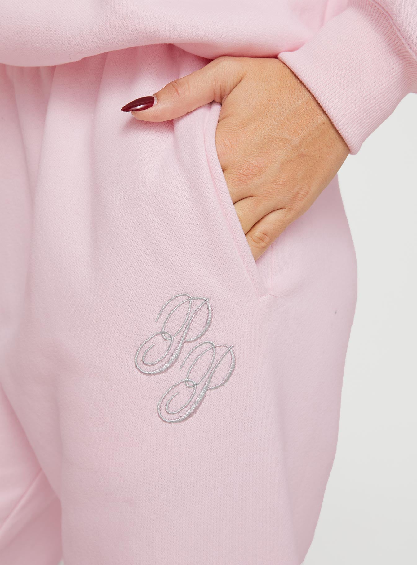 back view of model wearing Princess Polly Princess Polly Track Pants Script Baby Pink / Grey Mid Rise 