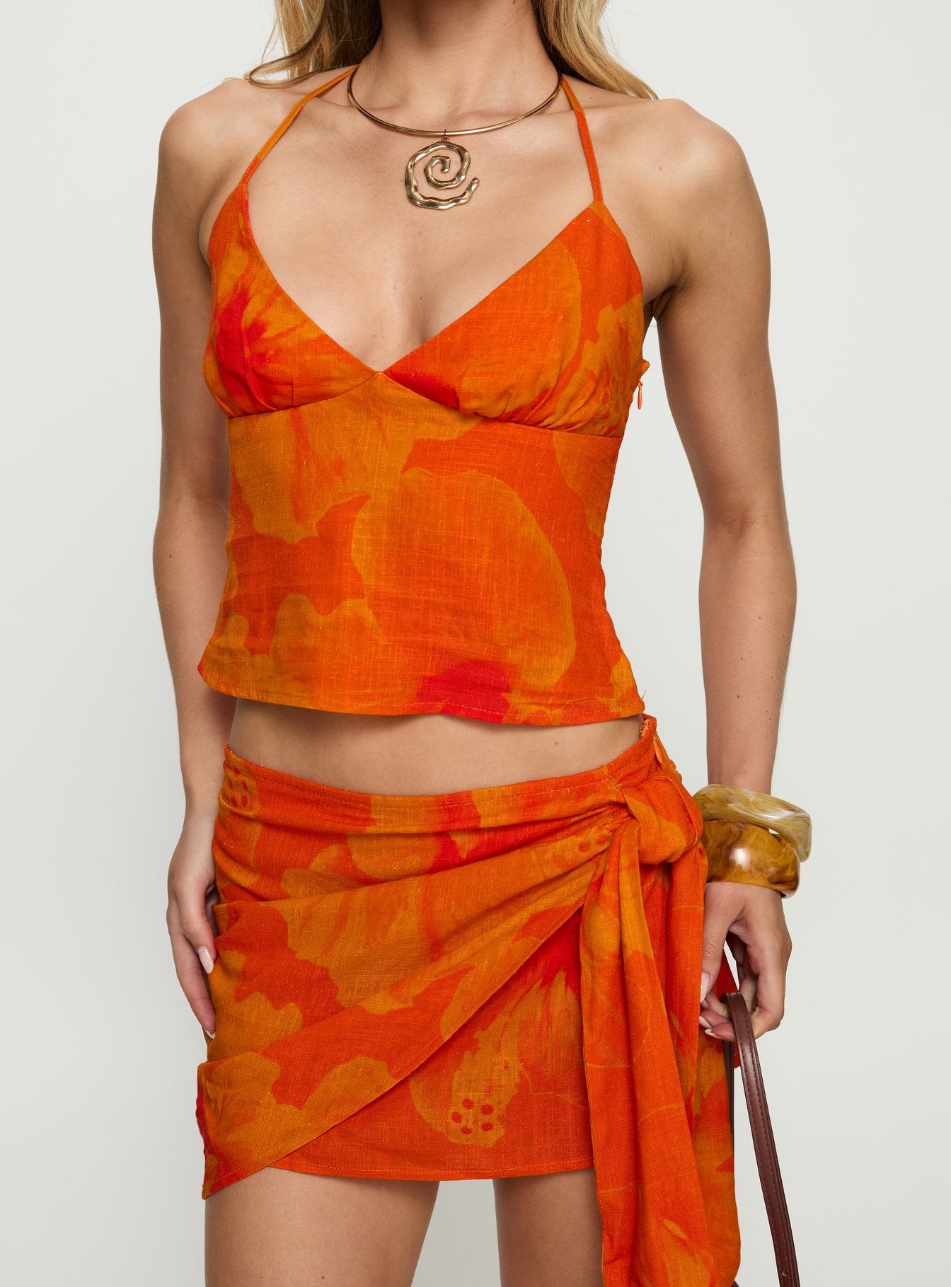 back view of model wearing Princess Polly Quintana Wrap Mini Skirt Orange Floral 